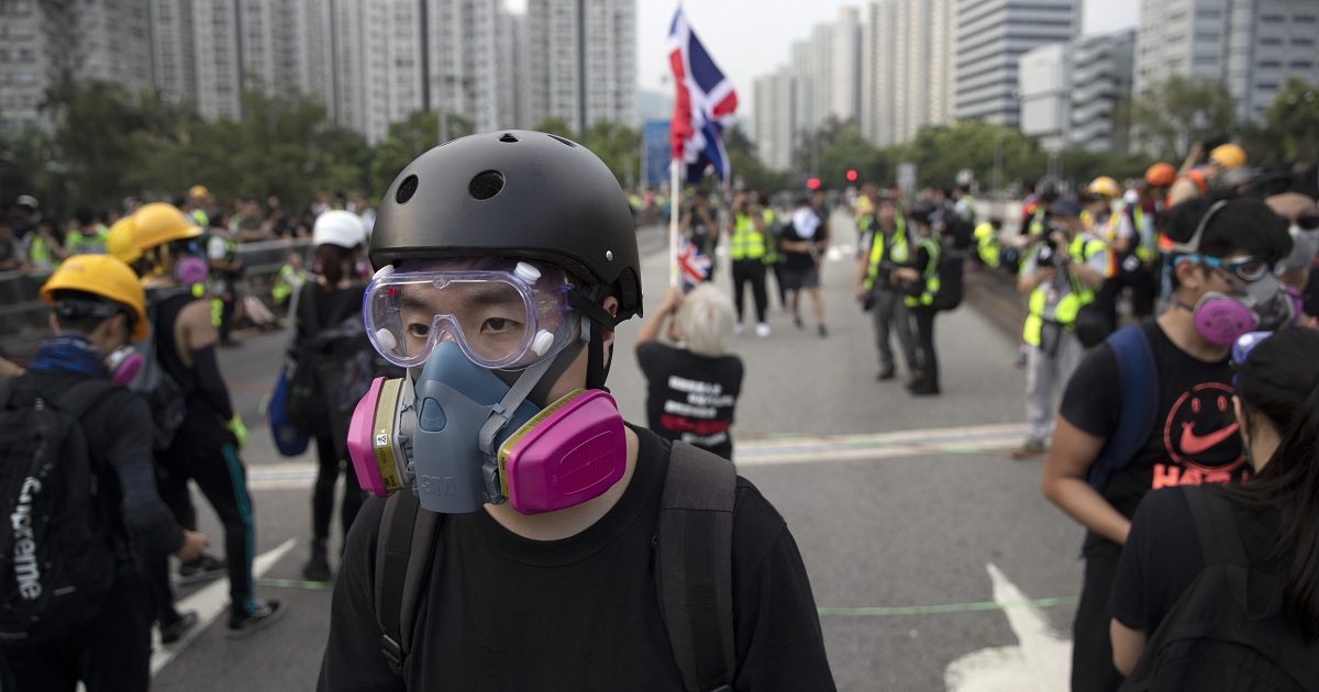 In this Aug. 16, 2019, photo, Wayne, a 33-year-old self-described “front line” protester, stands along with other demonstrators in Tai Po, on Hong Kong's outskirts. Hong Kong's protest movement has reached a moment of reckoning after protesters occupying the airport held two mainland Chinese men captive, and pro-democracy lawmakers and fellow demonstrators question whether the whole operation has gone too far. (AP Photo/Vincent Thian)