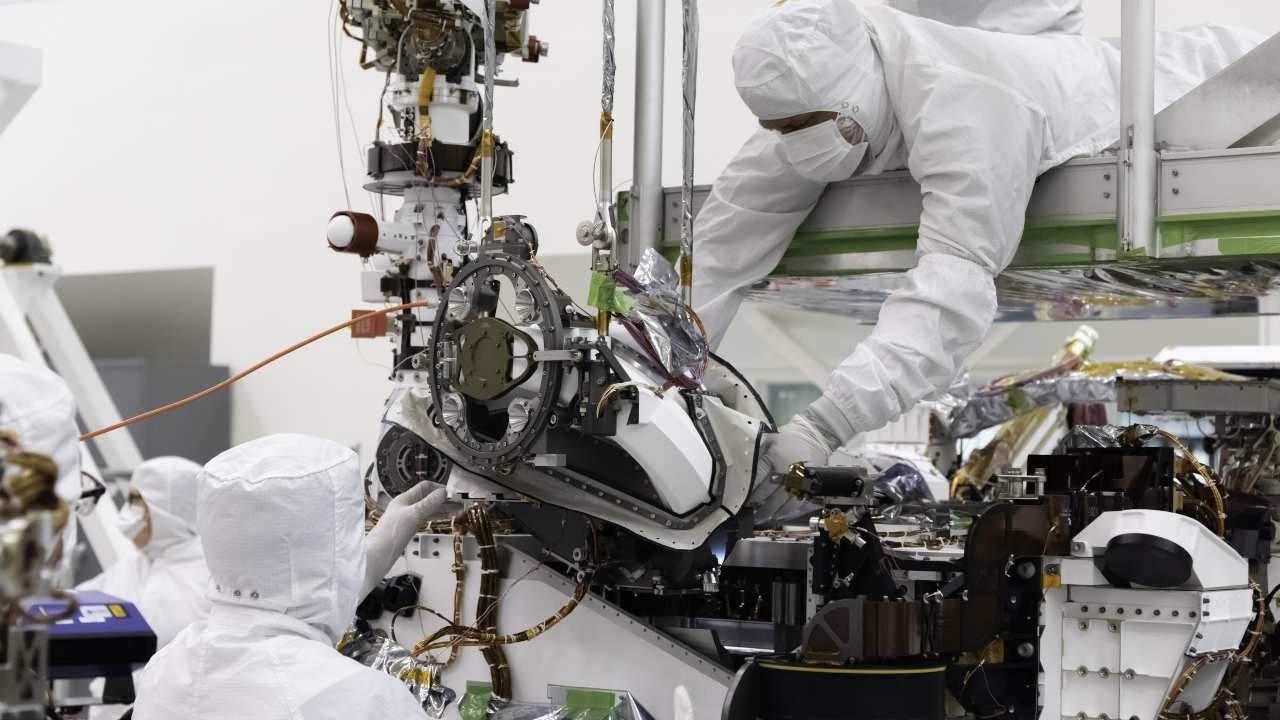 The 'bit carousel' on Mars 2020, a mechanism at the heart of the rover's Sample Caching System, is being taken tweaked by JPL engineers at the Spacecraft Assembly Facility's High Bay 1, JPL in this 5 August 2019 photo. Image: NASA