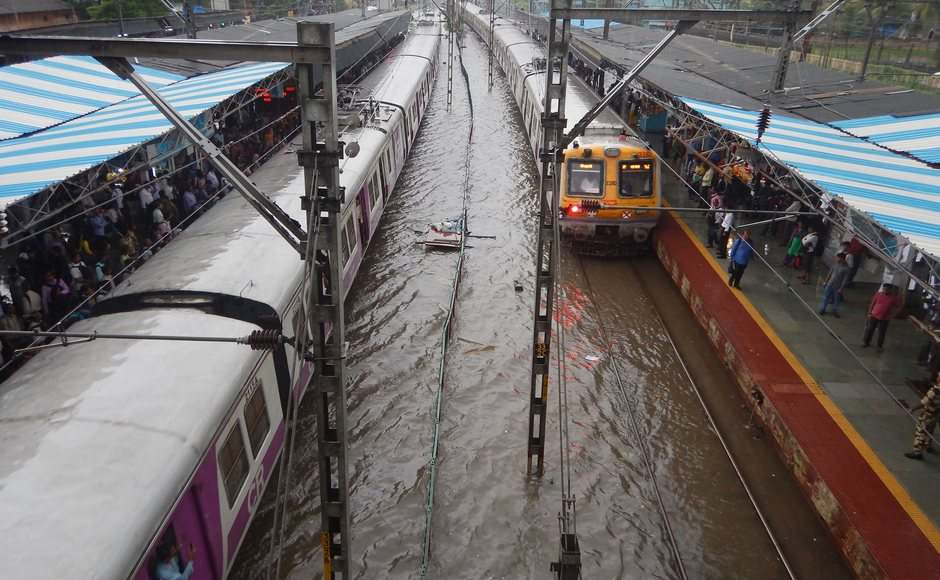 Water-logging on tracks disrupted the suburban train services, as locals on the Central and Harbour routes were running behind schedule by 15 minutes. In this picture, a view of waterlogged railway tracks can be seen following heavy rain in Thane. PTI Water-logging on tracks disrupted the suburban train services, as locals on the Central and Harbour routes were running behind schedule by 15 minutes. In this picture, a view of waterlogged railway tracks can be seen following heavy rain in Thane. PTI