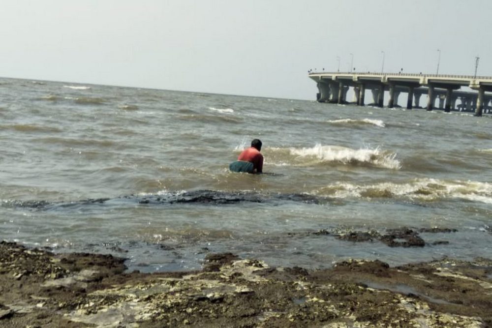 A fisherman looking for crabs and seashells near Worli, Mumbai. Image credit: Nikhil S. Dixit.