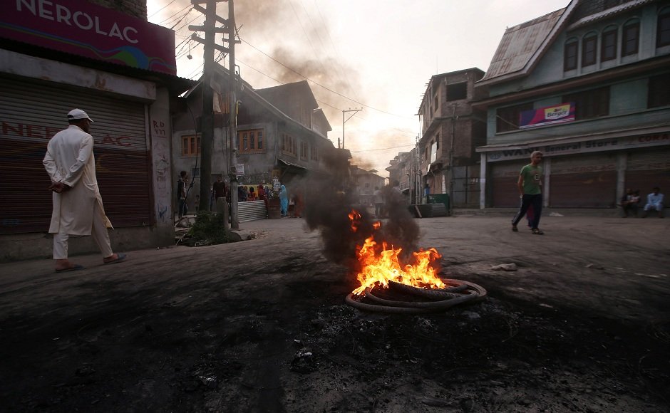 Vigilante groups set informal deadlines to carry out daily activities in some parts of the Valley before enforcing a day-time ‘civil curfew’, a move to protest the Centre’s decision to repeal the special status given to Jammu and Kashmir. Seen here is a man walking past burning tyres during a protest in Srinagar. Reuters Vigilante groups set informal deadlines to carry out daily activities in some parts of the Valley before enforcing a day-time ‘civil curfew’, a move to protest the Centre’s decision to repeal the special status given to Jammu and Kashmir. Seen here is a man walking past burning tyres during a protest in Srinagar. Reuters