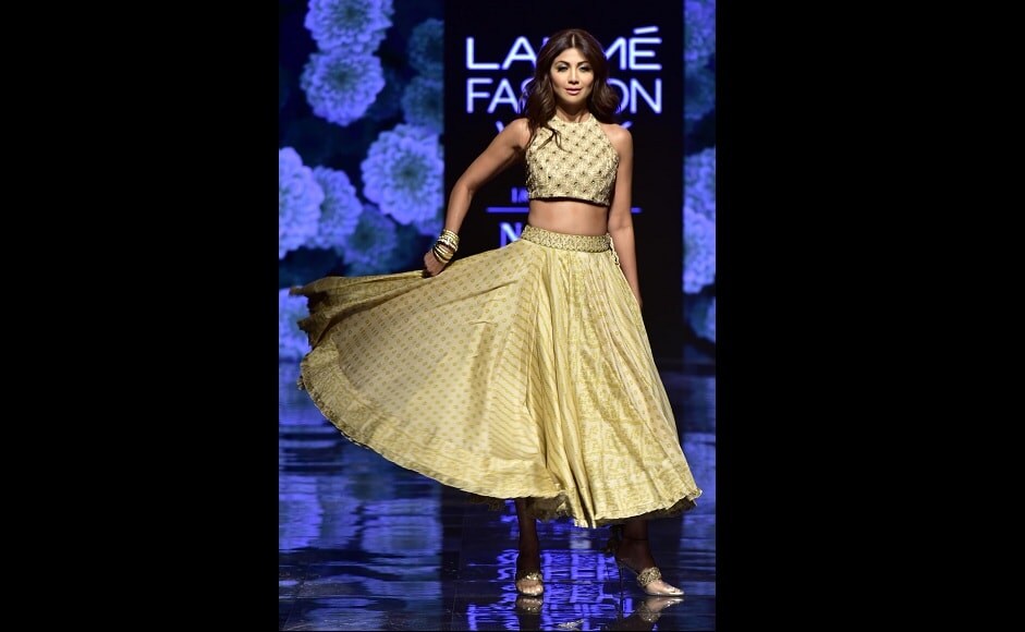 Shilpa Shetty wore a golden lehenga and a matching blouse as she walked down the ramp | Sachin Gokhale Shilpa Shetty wore a golden lehenga and a matching blouse as she walked down the ramp | Sachin Gokhale