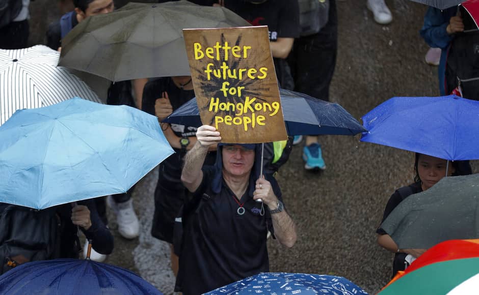 A man displays a placard as pro-democracy protesters gather for a rally in Hong Kong. AP A man displays a placard as pro-democracy protesters gather for a rally in Hong Kong. AP