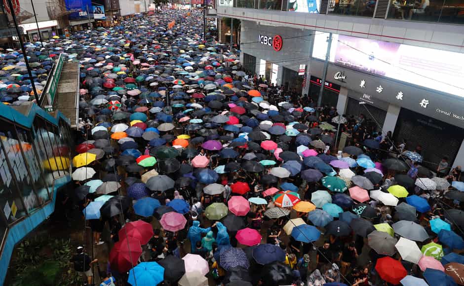 Heavy rain fell on tens of thousands of umbrella-ready protesters as they started marching from a packed park in central Hong Kong, where mass pro-democracy demonstrations have become a regular weekend activity. AP Heavy rain fell on tens of thousands of umbrella-ready protesters as they started marching from a packed park in central Hong Kong, where mass pro-democracy demonstrations have become a regular weekend activity. AP