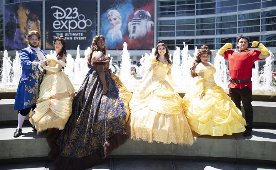 Fans posing as Belle from Beauty and the Beast in her iconic golden ball gown | The Walt Disney Company Fans posing as Belle from Beauty and the Beast in her iconic golden ball gown | The Walt Disney Company