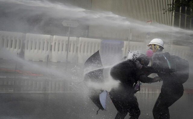 Protesters retreated but regrouped in the nearby Wan Chai neighborhood, setting a fire outside a subway station exit and on the streets. They fled again after riot police advanced. More than 1,300 people have been arrested amid increasing clashes between protesters and police. AP Protesters retreated but regrouped in the nearby Wan Chai neighborhood, setting a fire outside a subway station exit and on the streets. They fled again after riot police advanced. More than 1,300 people have been arrested amid increasing clashes between protesters and police. AP