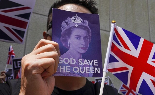 Hundreds of demonstrators sang "God Save the Queen" and "Rule Britannia" outside the consulate, waving the Union Jack as well as Hong Kong's colonial-era flags. Under a deal signed with Britain ahead of the city's 1997 handover to China, Hong Kong is allowed to keep its unique freedoms for 50 years. AP Hundreds of demonstrators sang "God Save the Queen" and "Rule Britannia" outside the consulate, waving the Union Jack as well as Hong Kong's colonial-era flags. Under a deal signed with Britain ahead of the city's 1997 handover to China, Hong Kong is allowed to keep its unique freedoms for 50 years. AP
