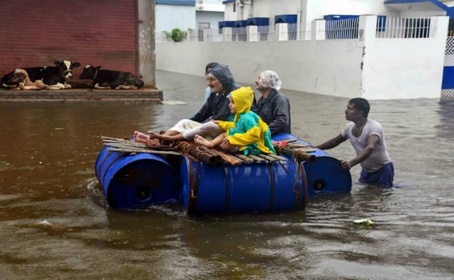 Peoples sit on a makeshift raft to cross the area of Sakha Maidan in Patna after heavy rainfall caused flooding in the region. According to the IMD, Patna will receive more rainfall accompanied by thunderstorms in the next few days. PTI Peoples sit on a makeshift raft to cross the area of Sakha Maidan in Patna after heavy rainfall caused flooding in the region. According to the IMD, Patna will receive more rainfall accompanied by thunderstorms in the next few days. PTI