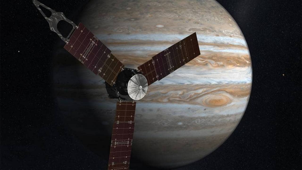 Artist illustration of the Juno satellite with Jupiter in  the background. image credit: NASA
