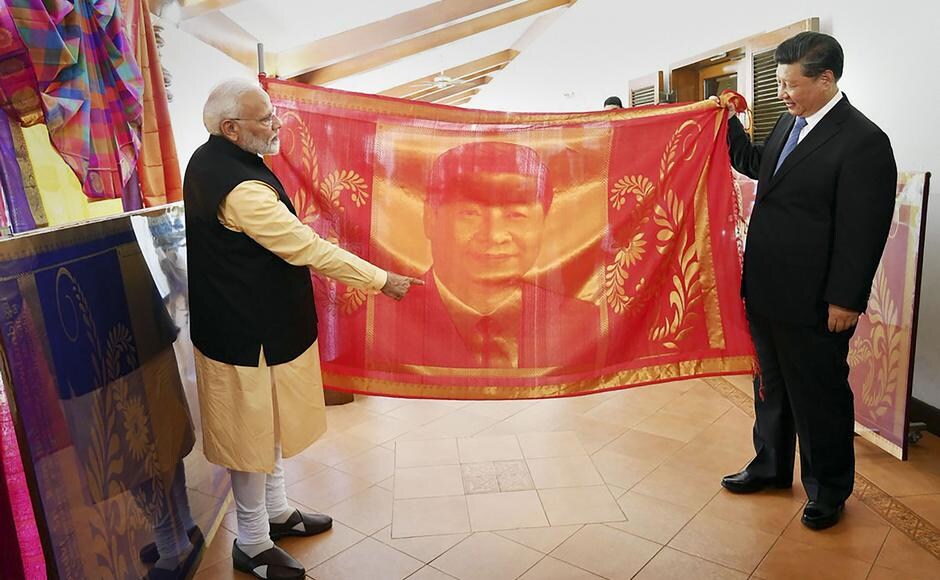 Modi gifted a handmade large sized silk shawl to Xi, which bore an embossment of the Chinese president in gold with zari embellishments on a bright red silk background. The shawl was made by weavers of a Coimbatore-based society. Jinping in return gifted a porcelain memento, which had Modi's image. Gifts presented to the Chinese leader on Friday included a Tanjore art painting from Poompuhar, a dancing Saraswati, a glass painting and a lamp. PTI Modi gifted a handmade large sized silk shawl to Xi, which bore an embossment of the Chinese president in gold with zari embellishments on a bright red silk background. The shawl was made by weavers of a Coimbatore-based society. Jinping in return gifted a porcelain memento, which had Modi's image. Gifts presented to the Chinese leader on Friday included a Tanjore art painting from Poompuhar, a dancing Saraswati, a glass painting and a lamp. PTI