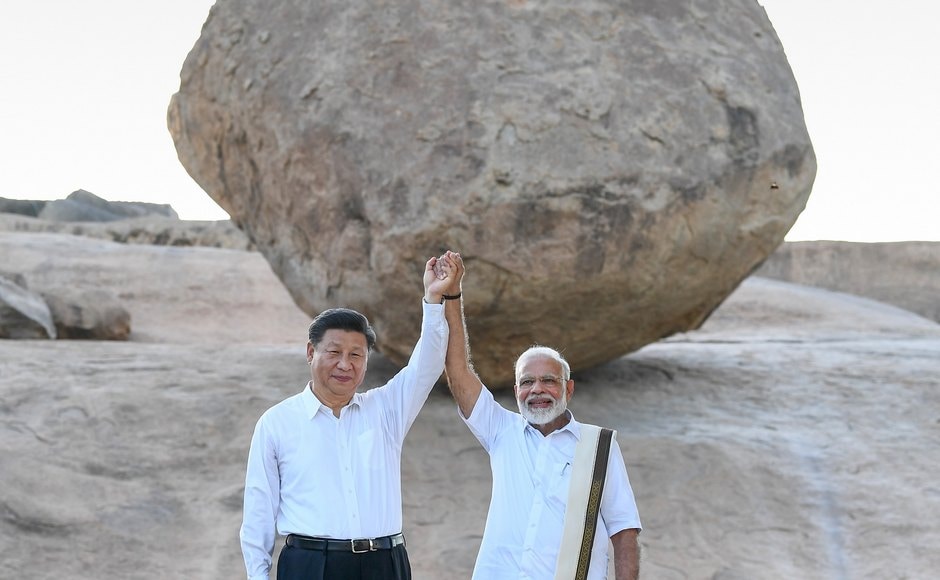 Dressed in a traditional <em>veshti</em>, <em>angavastram</em> and shirt, Modi strolled with Xi through the UNESCO world heritage sites of Arjuna's Penance, Krishna's Butterball, Pancha Ratha and Shore temple on Friday. PTI Dressed in a traditional <em>veshti</em>, <em>angavastram</em> and shirt, Modi strolled with Xi through the UNESCO world heritage sites of Arjuna's Penance, Krishna's Butterball, Pancha Ratha and Shore temple on Friday. PTI