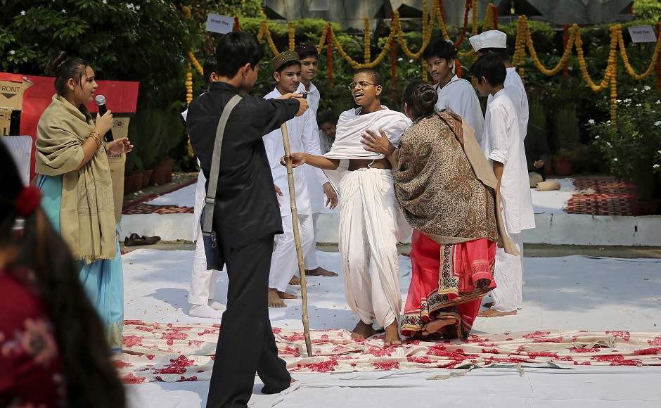 School children re-enact the assassination of Mahatma Gandhi during an event to celebrate Mahatma Gandhi’s 150th birth anniversary in New Delhi. AP School children re-enact the assassination of Mahatma Gandhi during an event to celebrate Mahatma Gandhi’s 150th birth anniversary in New Delhi. AP