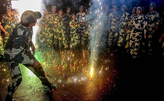 The Armed forces, too, celebrated the festival away from their families. Border Security Force (BSF) soldiers lit candles during Diwali celebrations near the international border fence in Agartala. PTI The Armed forces, too, celebrated the festival away from their families. Border Security Force (BSF) soldiers lit candles during Diwali celebrations near the international border fence in Agartala. PTI