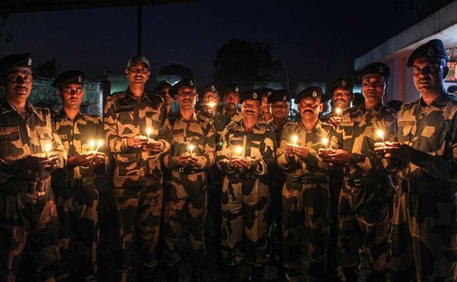 In Jammu, BSF soldiers took part in Diwali celebrations by lighting candles during near the International Border fence at Pargwa. PTI In Jammu, BSF soldiers took part in Diwali celebrations by lighting candles during near the International Border fence at Pargwa. PTI