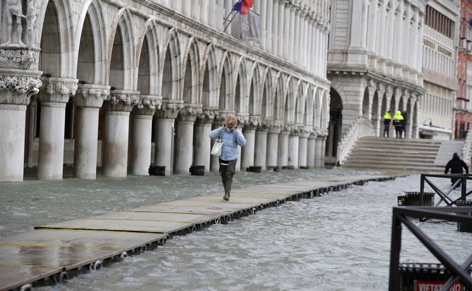 The renewed threat from exceptionally intense high tides came after a brief respite on Saturday, with visitors on Sunday morning having to walk along improvised gangways on St Mark's Square as the waters rose yet again. AP The renewed threat from exceptionally intense high tides came after a brief respite on Saturday, with visitors on Sunday morning having to walk along improvised gangways on St Mark's Square as the waters rose yet again. AP