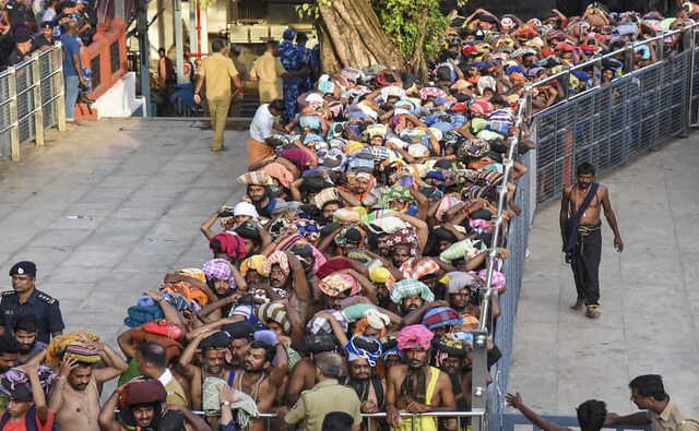 Devotees arrive at the Lord Ayyappa Temple in Sabarimala which opened on the second day of the annual Mandala Pooja on Sunday, days after the Supreme Court deferred a verdict on a petition seeking review of its judgment allowing the entry of women between the age of 10 to 50 years into the shrine, referring the case to a larger seven-member bench. PTI Devotees arrive at the Lord Ayyappa Temple in Sabarimala which opened on the second day of the annual Mandala Pooja on Sunday, days after the Supreme Court deferred a verdict on a petition seeking review of its judgment allowing the entry of women between the age of 10 to 50 years into the shrine, referring the case to a larger seven-member bench. PTI