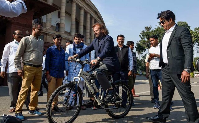 BJP MP Hans Raj Hans rides a bicycle as MPs Ravi Kishan and Manoj Tiwari look on. PTI BJP MP Hans Raj Hans rides a bicycle as MPs Ravi Kishan and Manoj Tiwari look on. PTI