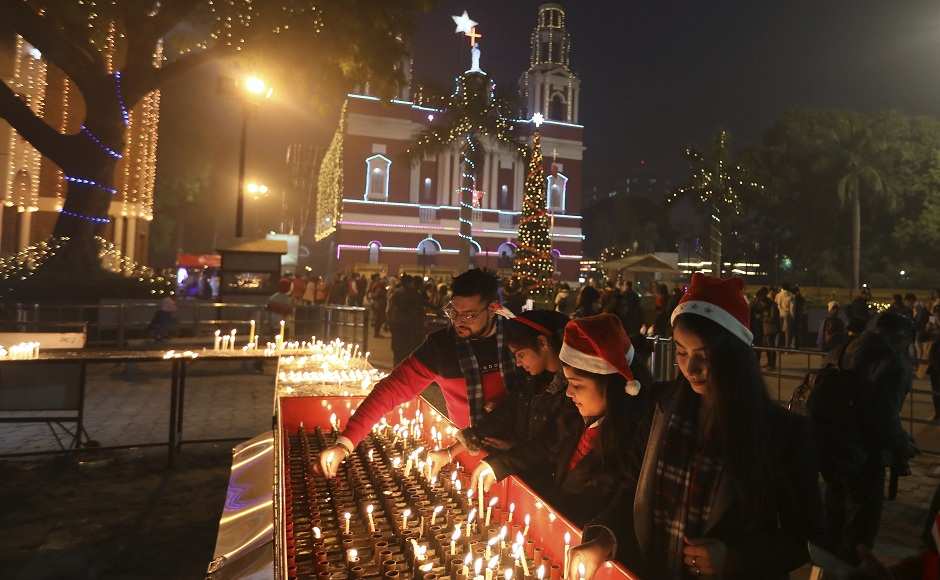 Indians light candles outside the Sacred Heart Cathedral on Christmas eve in New Delhi on Tuesday. Though the Hindus and Muslims comprise majority of the population in India, Christmas is a national holiday celebrated with much fanfare. AP Indians light candles outside the Sacred Heart Cathedral on Christmas eve in New Delhi on Tuesday. Though the Hindus and Muslims comprise majority of the population in India, Christmas is a national holiday celebrated with much fanfare. AP