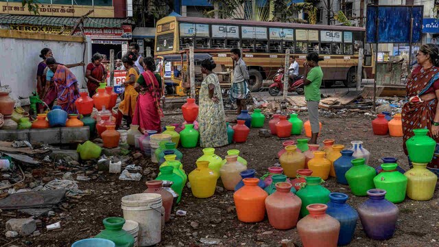 Residents of housing board complex in Chennai stand in line and fill water from common tap in June 2019. The locals say they get municipal water supply for two hours in the morning every alternate day. All four major reservoirs supplying water to Chennai have dried up. The only hope for the city to tide over the water crisis is the water in Veeranam lake, and the 2 desalination plants that supply 200 million litres a day (MLD) of water to the city besides groundwater supply/borewell. Image: Atul Loke/Getty Residents of housing board complex in Chennai stand in line and fill water from common tap in June 2019. The locals say they get municipal water supply for two hours in the morning every alternate day. All four major reservoirs supplying water to Chennai have dried up. The only hope for the city to tide over the water crisis is the water in Veeranam lake, and the 2 desalination plants that supply 200 million litres a day (MLD) of water to the city besides groundwater supply/borewell. Image: Atul Loke/Getty