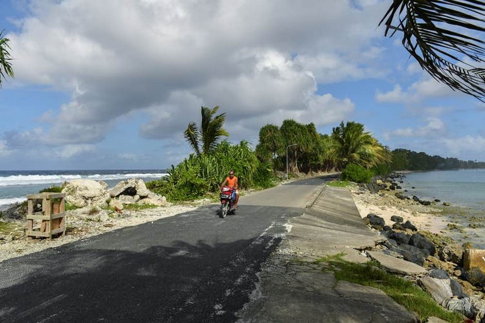 Low-lying islands such as Tuvalu are particularly vulnerable to sea level rise caused by climate change. Image credit: MICK TSIKAS/AAP