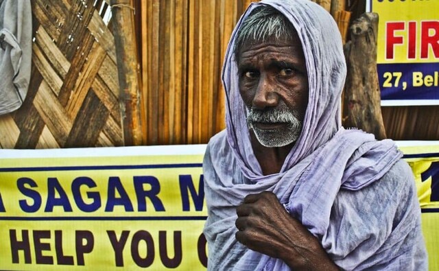 Another pilgrim, from Uttar Pradesh, stood shivering in the cold. He had lost his clothes after taking a dip in the river. Another pilgrim, from Uttar Pradesh, stood shivering in the cold. He had lost his clothes after taking a dip in the river.