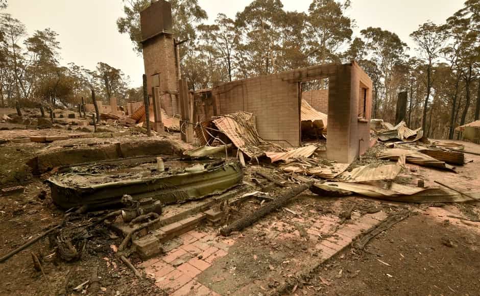 The remains of a house destroyed by a bushfire are seen just outside Batemans Bay in New South Wales. Australia authorised the forced evacuation of residents amid a mass exodus of tourists from fire-ravaged coastal communities. Getty Images The remains of a house destroyed by a bushfire are seen just outside Batemans Bay in New South Wales. Australia authorised the forced evacuation of residents amid a mass exodus of tourists from fire-ravaged coastal communities. Getty Images