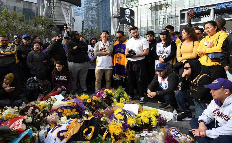 People gather at a memorial for Kobe Bryant near Staples Center Sunday in Los Angeles. AP People gather at a memorial for Kobe Bryant near Staples Center Sunday in Los Angeles. AP