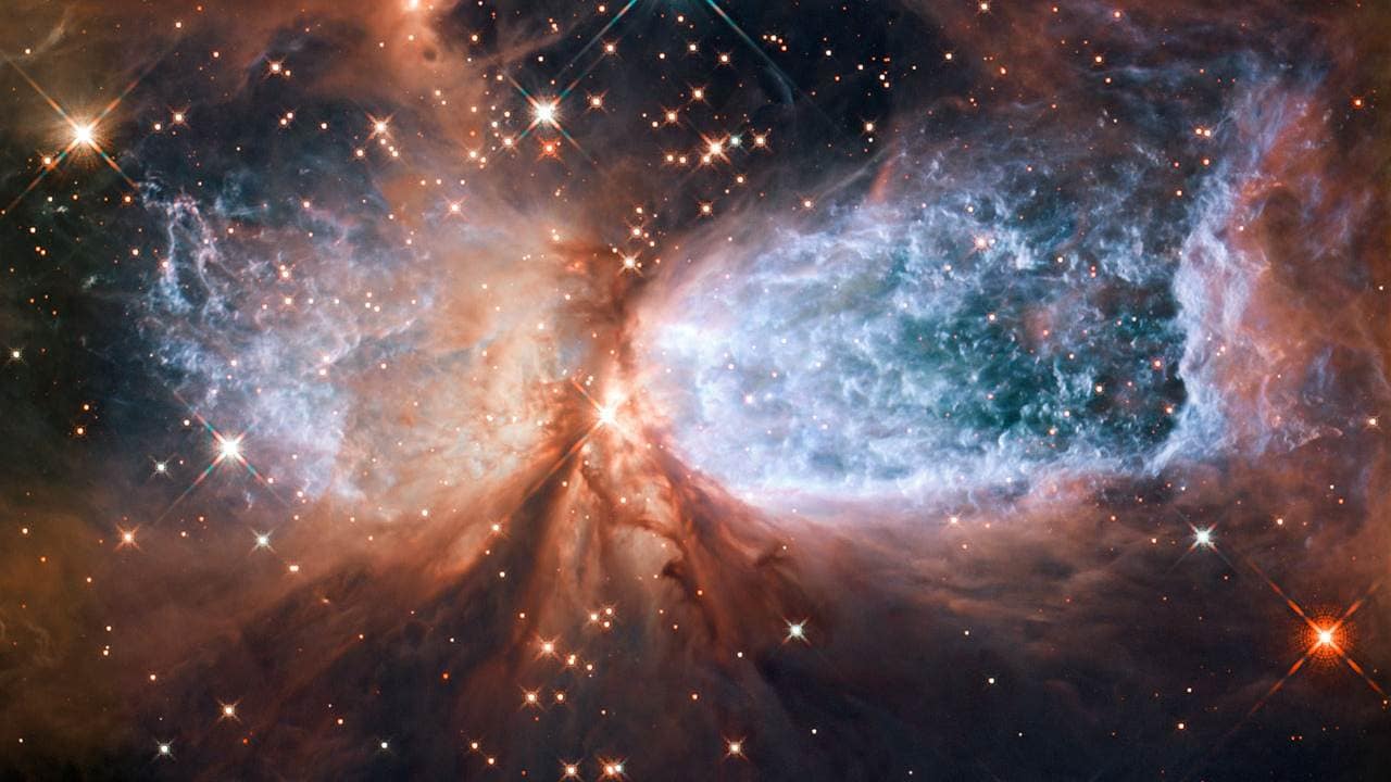The 2011 composite image of Sh 2-106 shows a newly formed star at the centre that is shrouded in dust and gas. The glowing blue light is hydrogen gas. Image credit: ESA/Hubble The 2011 composite image of Sh 2-106 shows a newly formed star at the centre that is shrouded in dust and gas. The glowing blue light is hydrogen gas. Image credit: ESA/Hubble