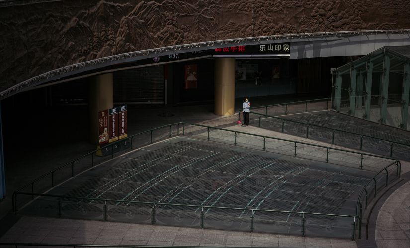 A cleaner at the empty Tianfu Square Metro Station in Chengdu, China. Yuyang Liu © 2020 The New York Times