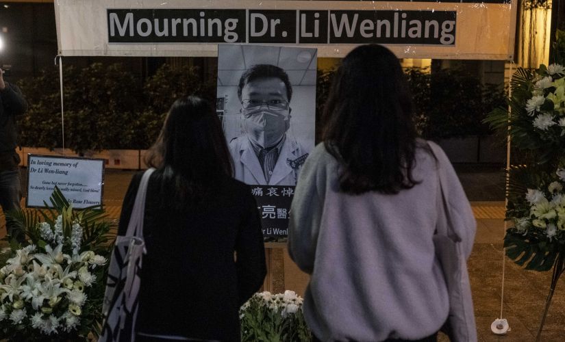 People pay respects at a memorial to Li Wenliang, who was silenced by the police for being one of the first to warn about the coronavirus, in Hong Kong. Lam Yik Fei © 2020 The New York Times