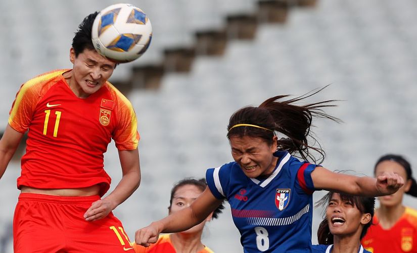 Wang Shanshan of China, left, goes up for a header against Chinese Taipei's Wang Hsiang-Huei during their Olympic soccer qualifying match in Sydney, Friday, Feb. 10, 2020. (AP Photo/Steve Christo)
