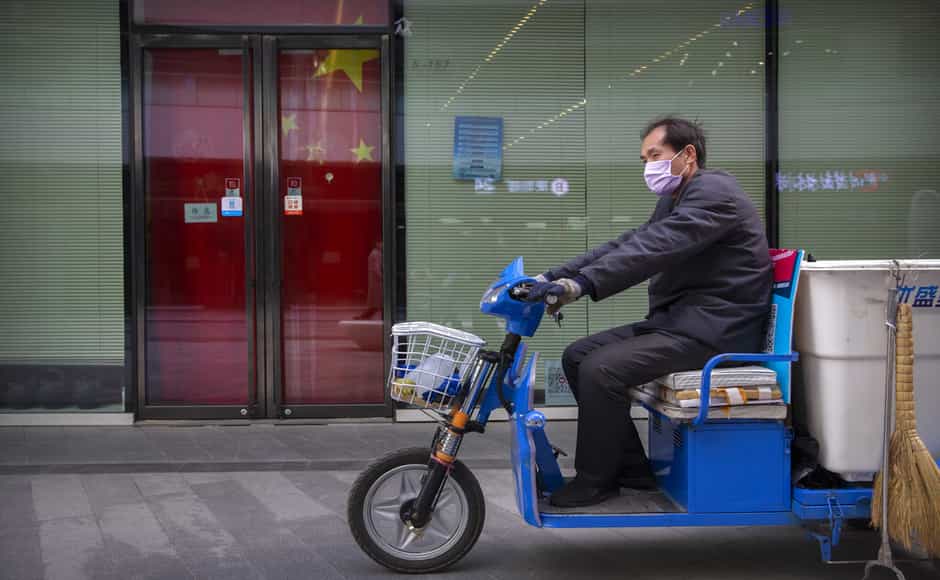 A worker wears a face mask as he rides a cart past a closed shop in Beijing. Thursday marked the first time since 20 January that Wuhan showed no new locally transmitted cases. Wuhan has been under a strict lockdown since January. AP A worker wears a face mask as he rides a cart past a closed shop in Beijing. Thursday marked the first time since 20 January that Wuhan showed no new locally transmitted cases. Wuhan has been under a strict lockdown since January. AP