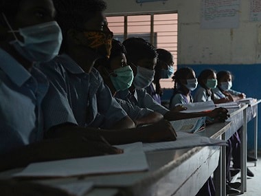 Indian students wear masks at a government school in Hyderabad. AP