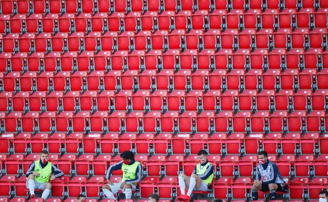 Mask wearing substitutes, dispersed in the stands to keep them apart, cheered their on-field teammates from the sidelines. AP Mask wearing substitutes, dispersed in the stands to keep them apart, cheered their on-field teammates from the sidelines. AP
