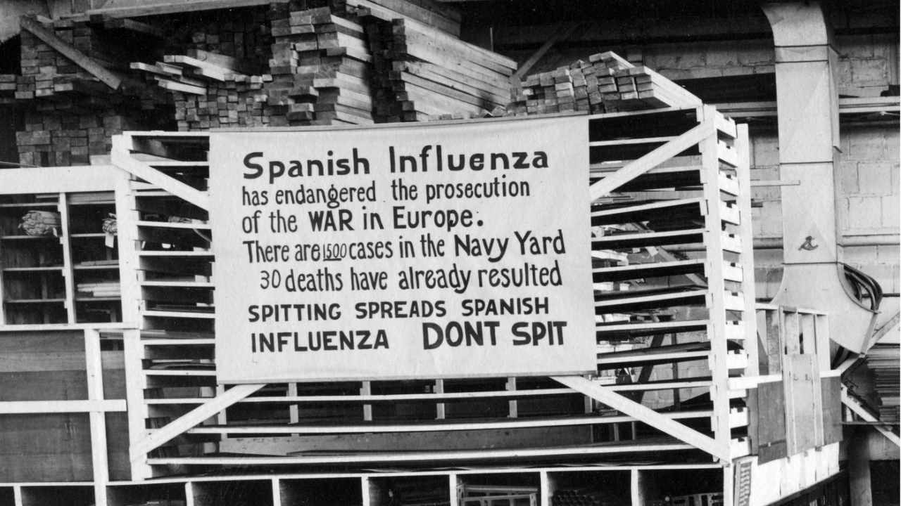 In this Oct. 19, 1918 file photo provide by the U.S. Naval History and Heritage Command a sign is posted at the Naval Aircraft Factory in Philadelphia that indicates, the Spanish Influenza was then extremely active. Image credit: U.S. Naval History and Heritage Command via AP
