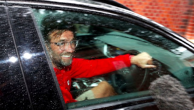 Liverpool manager Jurgen Klopp is mobbed by members of the press outside his residence after his team clinched the top flight title for the first time in 30 years. AP Liverpool manager Jurgen Klopp is mobbed by members of the press outside his residence after his team clinched the top flight title for the first time in 30 years. AP