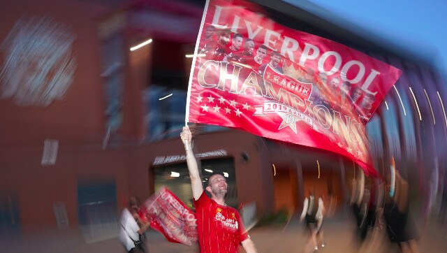 A fan waves a team flag complete with pictures of members of the victorious 2019-20 squad. AP A fan waves a team flag complete with pictures of members of the victorious 2019-20 squad. AP