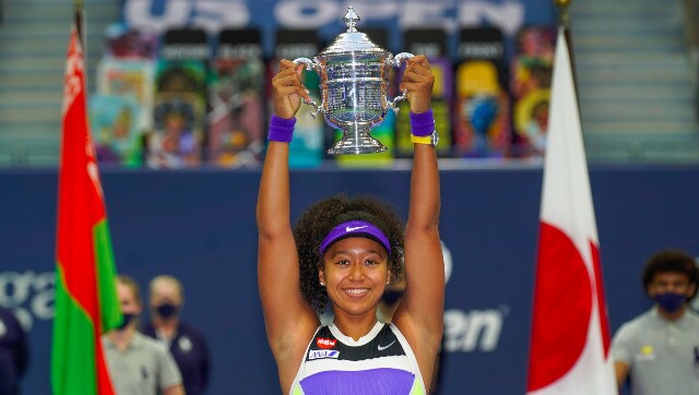 Naomi Osaka holds aloft the championship trophy after winning the US Open for a second time. AP Naomi Osaka holds aloft the championship trophy after winning the US Open for a second time. AP