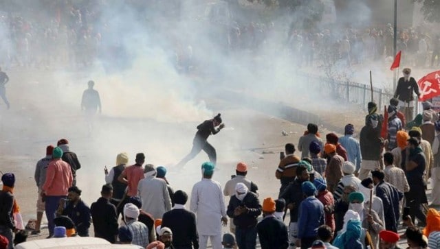 Police use tear gas to disperse agitating farmers gathered at Singhu border entry point in Delhi as part of their 'Delhi Chalo' protest against the Narendra Modi government's new farm laws. PTI Police use tear gas to disperse agitating farmers gathered at Singhu border entry point in Delhi as part of their 'Delhi Chalo' protest against the Narendra Modi government's new farm laws. PTI