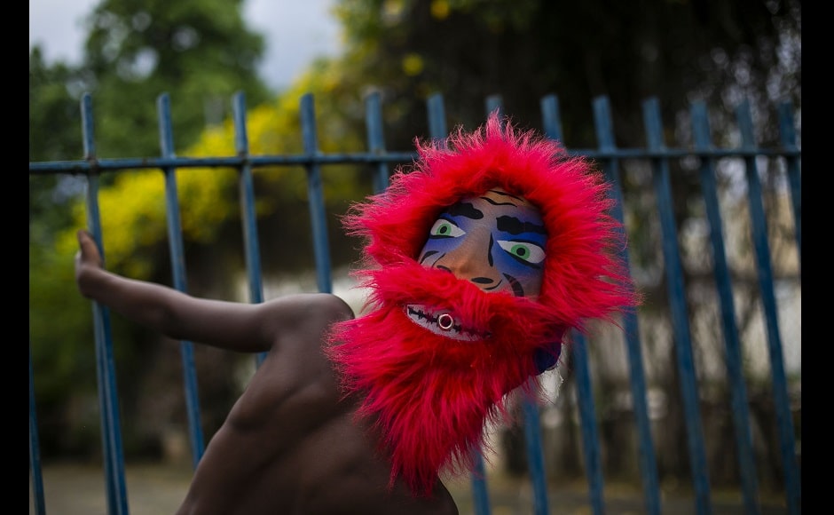 <br />Some Carnival fans met in small groups of “bate-bolas” or ball hitters group - revellers who dress up in exuberant, identical, hand-made costumes known as “fantasias” each Carnival — for symbolic celebrations on Saturday. Image via The Associated Press/Bruna Prado <br />Some Carnival fans met in small groups of “bate-bolas” or ball hitters group - revellers who dress up in exuberant, identical, hand-made costumes known as “fantasias” each Carnival — for symbolic celebrations on Saturday. Image via The Associated Press/Bruna Prado