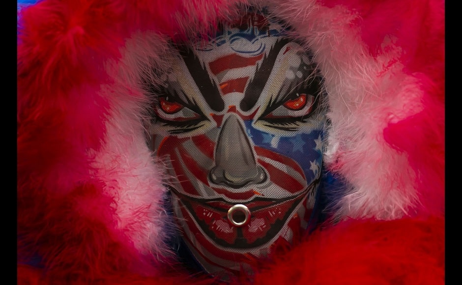 A member of a “bate-bola” eyes the camera during a brief appearance as part of a Carnival tradition despite restrictions due to the new coronavirus pandemic, in Rio de Janeiro. “On the day we parade, it’s magical, fantastic. People come, the street is packed but this year we won’t have this. We feel a void, people say something is missing,” said a person involved with a group of bate-bolas for the last 31 years. Image via The Associated Press/Bruna Prado A member of a “bate-bola” eyes the camera during a brief appearance as part of a Carnival tradition despite restrictions due to the new coronavirus pandemic, in Rio de Janeiro. “On the day we parade, it’s magical, fantastic. People come, the street is packed but this year we won’t have this. We feel a void, people say something is missing,” said a person involved with a group of bate-bolas for the last 31 years. Image via The Associated Press/Bruna Prado