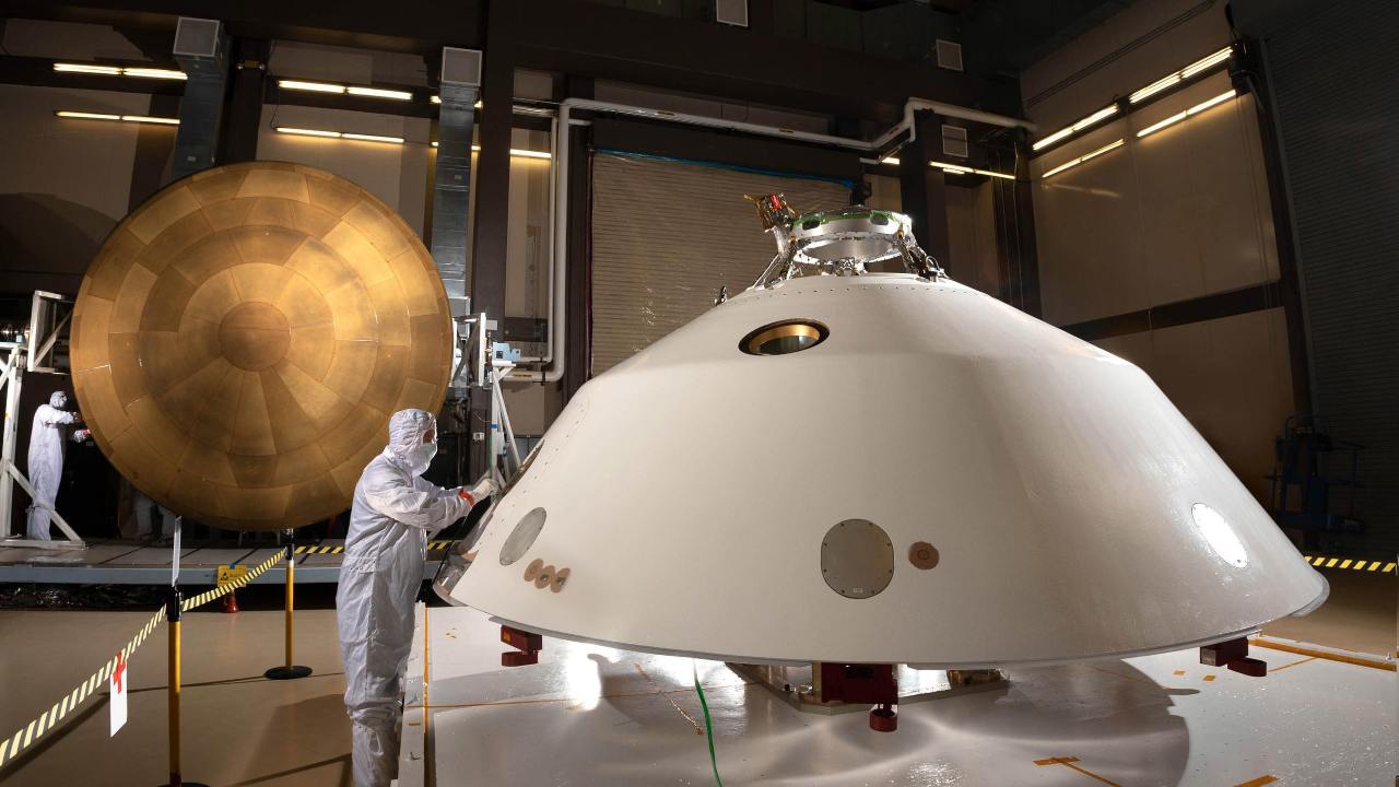 Pictured are the Mars 2020 backshell heat shield (foreground) and the main PICA heat shield (background).  Image credit: NASA/JPL-Caltech