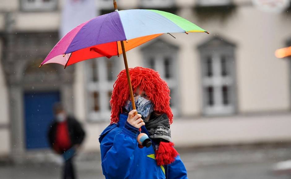 Parades, street festivals and other large gatherings have all been cancelled in Germany this year. But organisers in Duesseldorf, one of the German Rhineland's main Carnival strongholds, didn't want to let Rose Monday in 2021 go completely without the traditional caricatures of current events. Here, a young carnival reveller dressed as a clown holds an umbrella in the empty old town in Duesseldorf. AP Photo/Martin Meissner Parades, street festivals and other large gatherings have all been cancelled in Germany this year. But organisers in Duesseldorf, one of the German Rhineland's main Carnival strongholds, didn't want to let Rose Monday in 2021 go completely without the traditional caricatures of current events. Here, a young carnival reveller dressed as a clown holds an umbrella in the empty old town in Duesseldorf. AP Photo/Martin Meissner