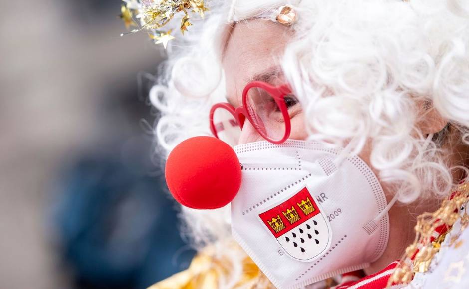 Carnival reveller Ingrid Kuellheim wears a face mask to protect against the coronavirus as she walks in disguise long the route, usually taken by the carnival parade Rosenmontagszug, in Cologne, Germany, Monday. Because of the coronavirus pandemic the traditional carnival parades are canceled. Marius Becker/dpa via AP Carnival reveller Ingrid Kuellheim wears a face mask to protect against the coronavirus as she walks in disguise long the route, usually taken by the carnival parade Rosenmontagszug, in Cologne, Germany, Monday. Because of the coronavirus pandemic the traditional carnival parades are canceled. Marius Becker/dpa via AP