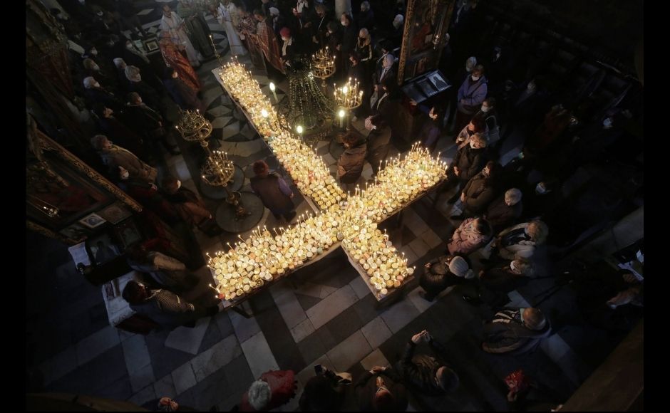 Worshippers gather around candles stuck to jars of honey, arranged as a cross, during mass for the 'sanctification of honey' at the Presentation of the Blessed Virgin church in the town of Blagoevgrad, south of the Bulgarian capital of Sofia, Wednesday, 10 February, 2021. Despite the COVID19 pandemic, Bulgarian Orthodox Church marks the day of St Haralampus, Orthodox patron saint of bee-keepers, by performing a ritual for health and rich harvest. Photo via The Associated Press/Valentina Petrova Worshippers gather around candles stuck to jars of honey, arranged as a cross, during mass for the 'sanctification of honey' at the Presentation of the Blessed Virgin church in the town of Blagoevgrad, south of the Bulgarian capital of Sofia, Wednesday, 10 February, 2021. Despite the COVID19 pandemic, Bulgarian Orthodox Church marks the day of St Haralampus, Orthodox patron saint of bee-keepers, by performing a ritual for health and rich harvest. Photo via The Associated Press/Valentina Petrova