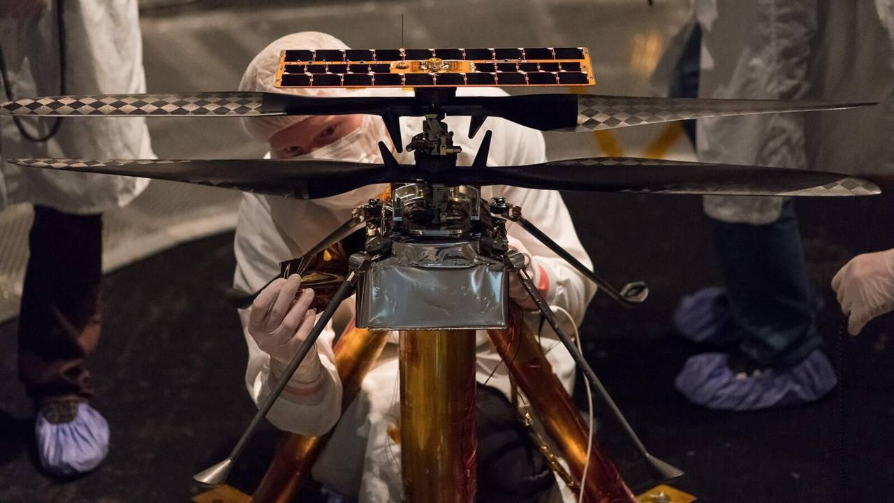 The Ingenuity team attaches a piece to the flight model in early 2019. Image: NASA/JPL-Caltech