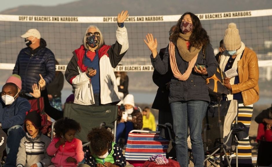 Members of the Veal family and friends join in praying during the Westside Easter Sunrise Service at Will Rogers State Beach park on the Santa Monica Bay on the Pacific Coast in the Pacific Palisades neighborhood of Los Angeles. Photo via The Associated Press/Damian Dovarganes Members of the Veal family and friends join in praying during the Westside Easter Sunrise Service at Will Rogers State Beach park on the Santa Monica Bay on the Pacific Coast in the Pacific Palisades neighborhood of Los Angeles. Photo via The Associated Press/Damian Dovarganes