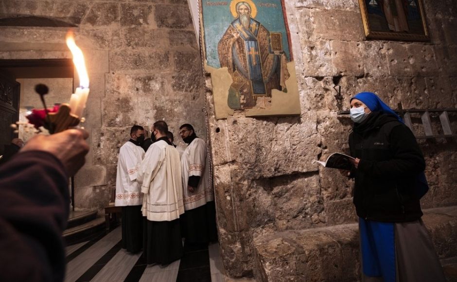 Priests and a nun wearing face masks attend Easter Sunday Mass at the Church of the Holy Sepulchre, where many Christians believe Jesus was crucified, buried and rose from the dead, in the Old City of Jerusalem on Sunday, 4 April, 2021. Photo via The Associated Press/Oded Balilty Priests and a nun wearing face masks attend Easter Sunday Mass at the Church of the Holy Sepulchre, where many Christians believe Jesus was crucified, buried and rose from the dead, in the Old City of Jerusalem on Sunday, 4 April, 2021. Photo via The Associated Press/Oded Balilty