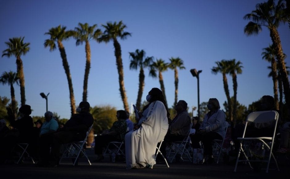 People attend an Easter sunrise service at the Palm Eastern Mortuary and Cemetery in Las Vegas. Photo via The Associated Press/John Locher People attend an Easter sunrise service at the Palm Eastern Mortuary and Cemetery in Las Vegas. Photo via The Associated Press/John Locher