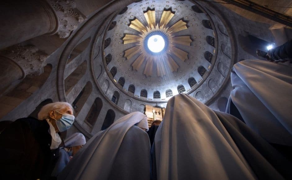 A woman wearing a face mask attends Easter Sunday Mass led by Latin Patriarch of Jerusalem Pierbattista Pizzaballa at the Church of the Holy Sepulchre, where many Christians believe Jesus was crucified, buried and rose from the dead, in the Old City of Jerusalem. Photo via The Associated Press/Oded Balilty A woman wearing a face mask attends Easter Sunday Mass led by Latin Patriarch of Jerusalem Pierbattista Pizzaballa at the Church of the Holy Sepulchre, where many Christians believe Jesus was crucified, buried and rose from the dead, in the Old City of Jerusalem. Photo via The Associated Press/Oded Balilty